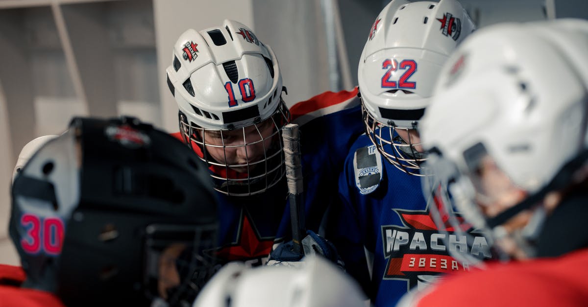 How do I increase my Team Rank and what does it get me? - Hockey Players Wearing Helmet in the Locker Room