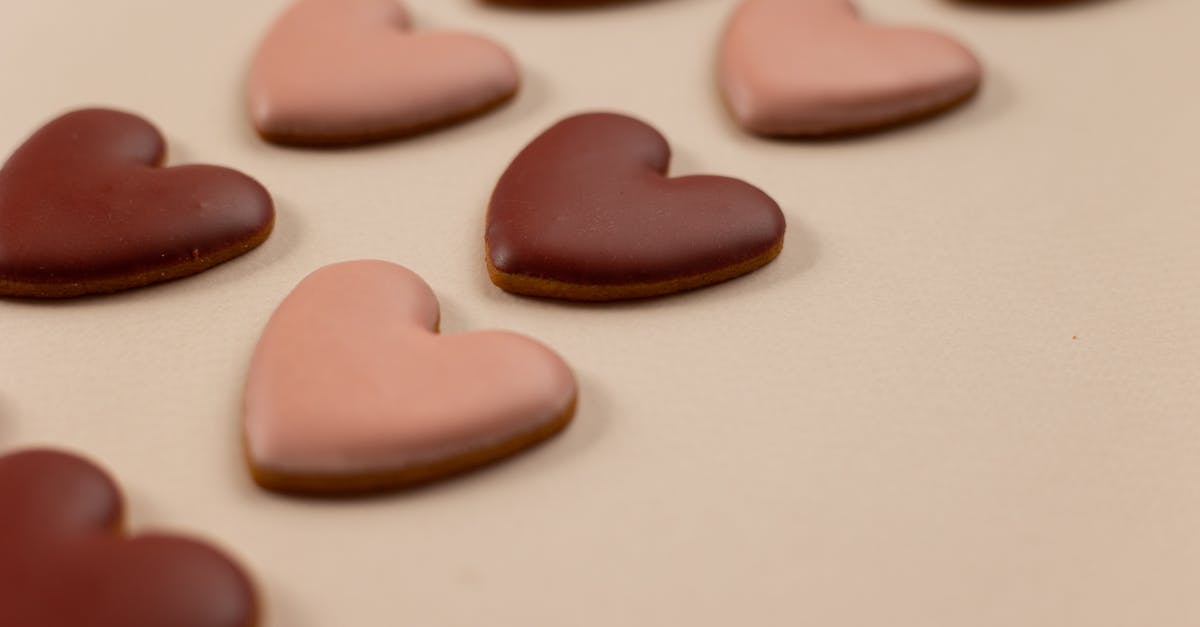 How do I initiate the DLC missions in Saints Row 4? - From above of red and pink heart shaped cookies with frosting arranged in rows on beige background during valentines day
