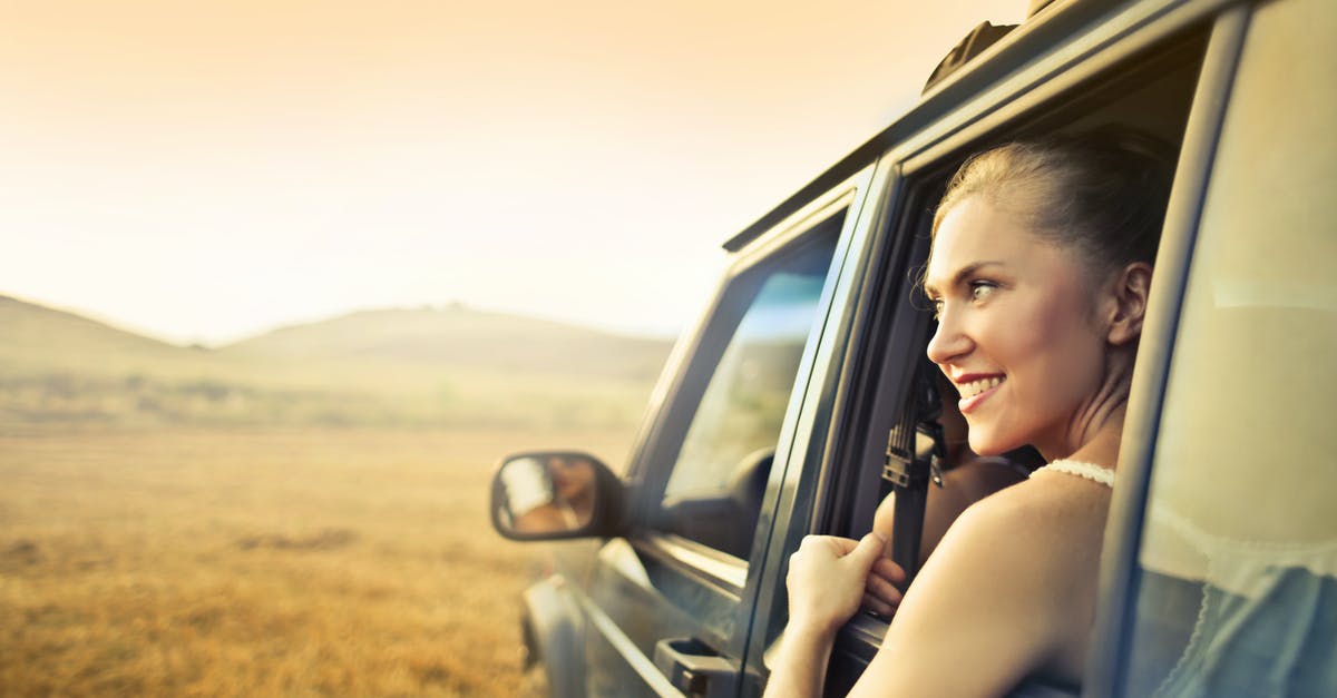 How do I keep the Resources overlay open while placing roads? - Young happy female smiling and enjoying sunset through open window while traveling by car