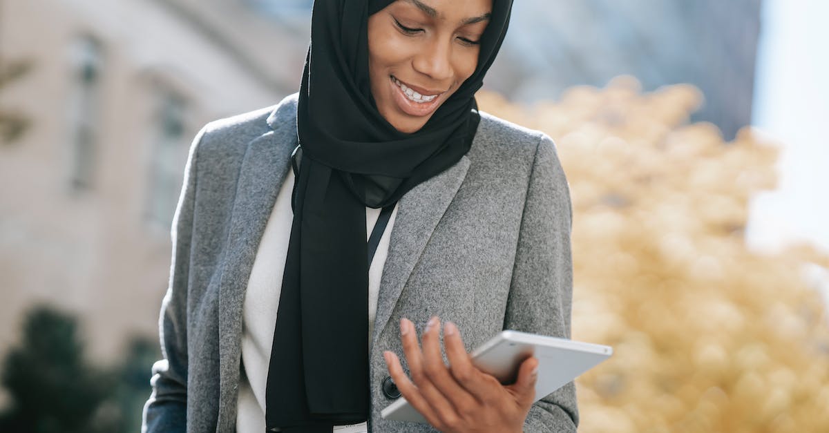 How do I kill Ambassador Brenner? - Black woman in hijab browsing tablet How do I kill Ambassador Brenner? - Black woman in hijab browsing tablet