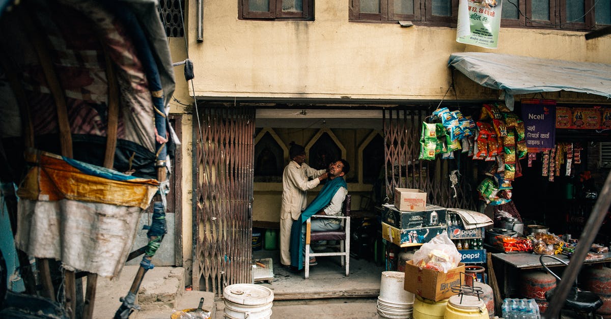 How do I know how many posters I have to stick to my enemies? - Unrecognizable barber cutting beard to ethnic client in poor barbershop How do I know how many posters I have to stick to my enemies? - Unrecognizable barber cutting beard to ethnic client in poor barbershop
