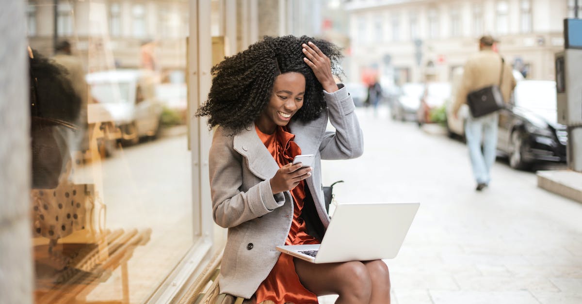 How do I know if a city is connected by wireless? - Woman in Gray Coat Sitting On Wooden bench