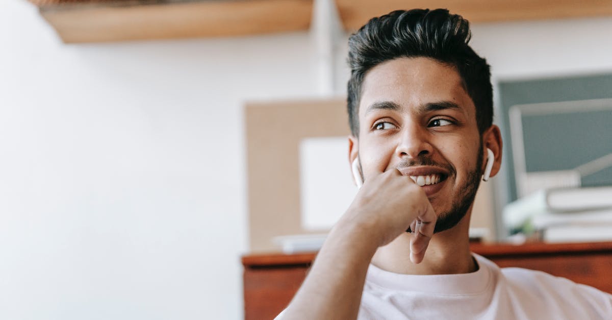 How do I know their favorite food? - Happy ethnic man listening to music in earbuds