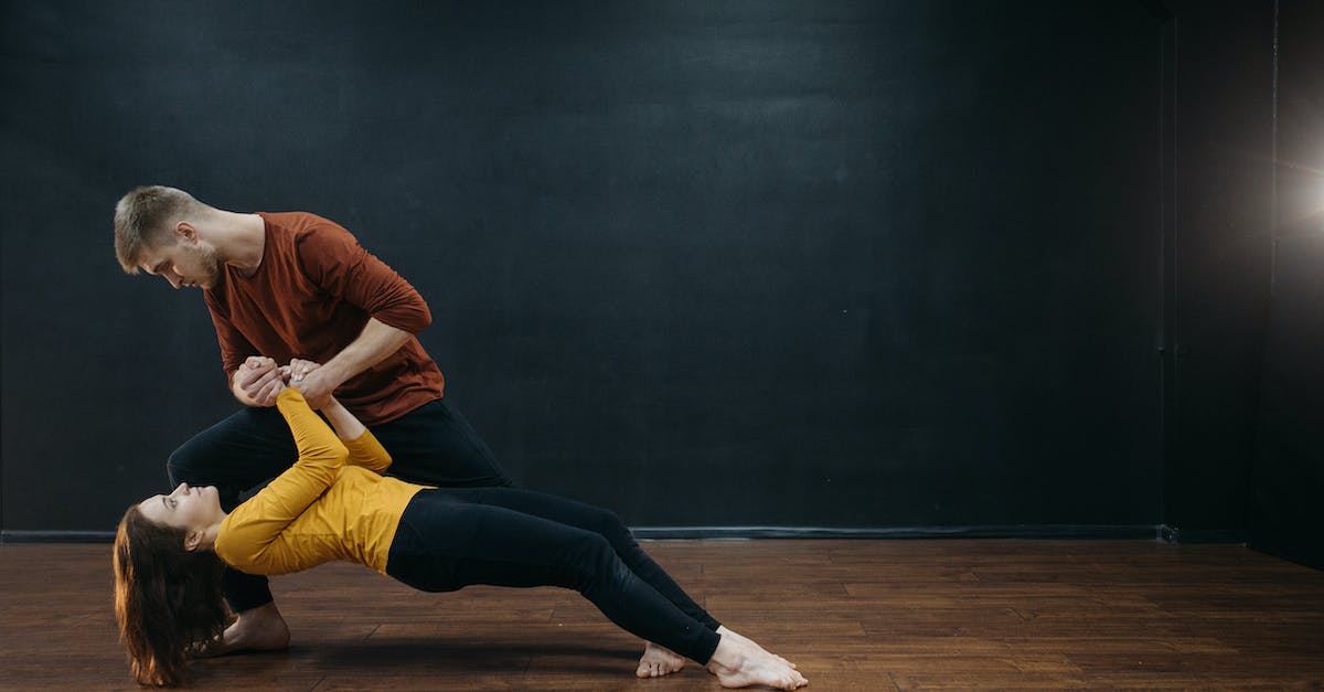 How do I leave the dance floor? - Man in Orange Long Sleeve Shirt and Yellow Pants Sitting on Black Floor