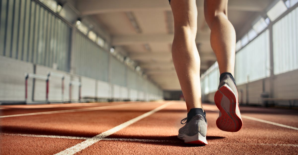 How do i level up archery fast in skyrim? [duplicate] - From below back view of crop strong runner walking along running track in athletics arena while doing warm up exercises during workout