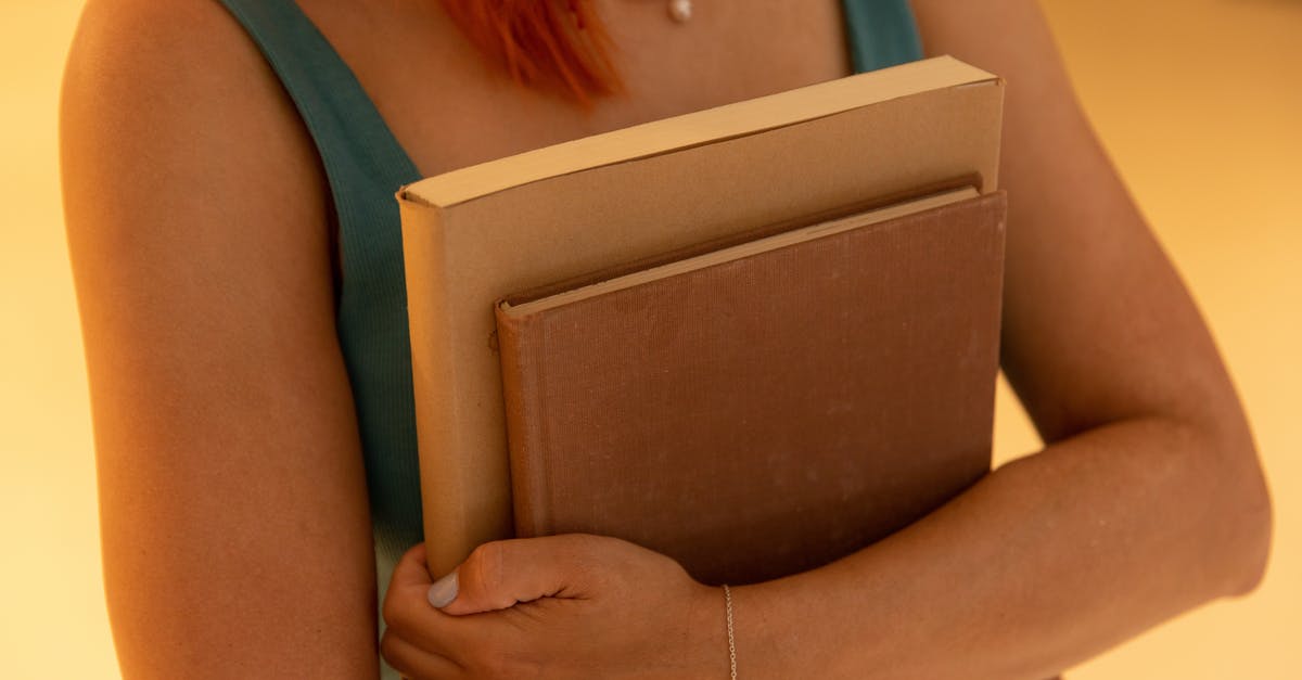 How do I level up guns? - A Person in Green Tank Top Holding Blue Books