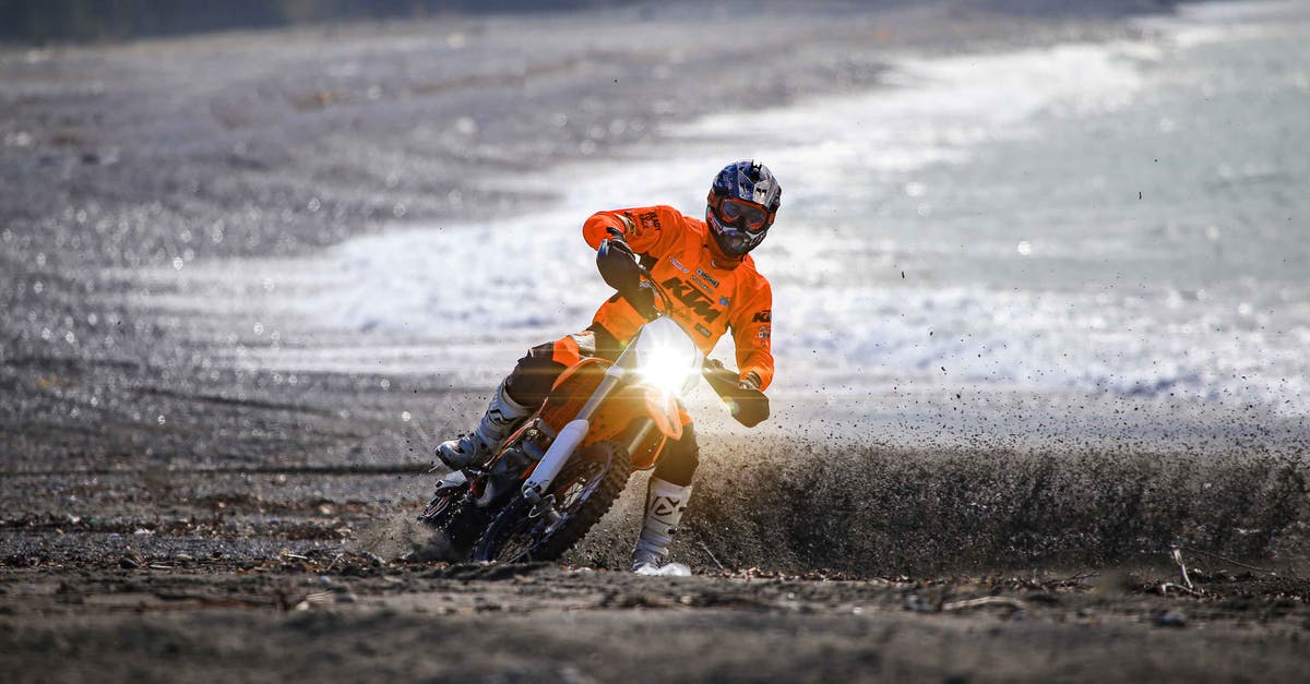How do I make a Beacon Ride an invisible silverfish? - Man in Orange Jacket and Black Helmet Sitting on Beach Shore