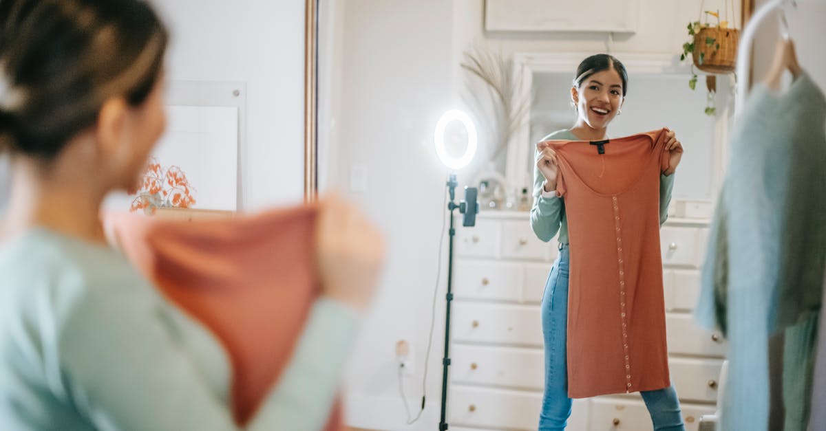How do I make house appear in the happy home show case because it was empty? - Happy ethnic lady filming vlog on mobile while demonstrating dress