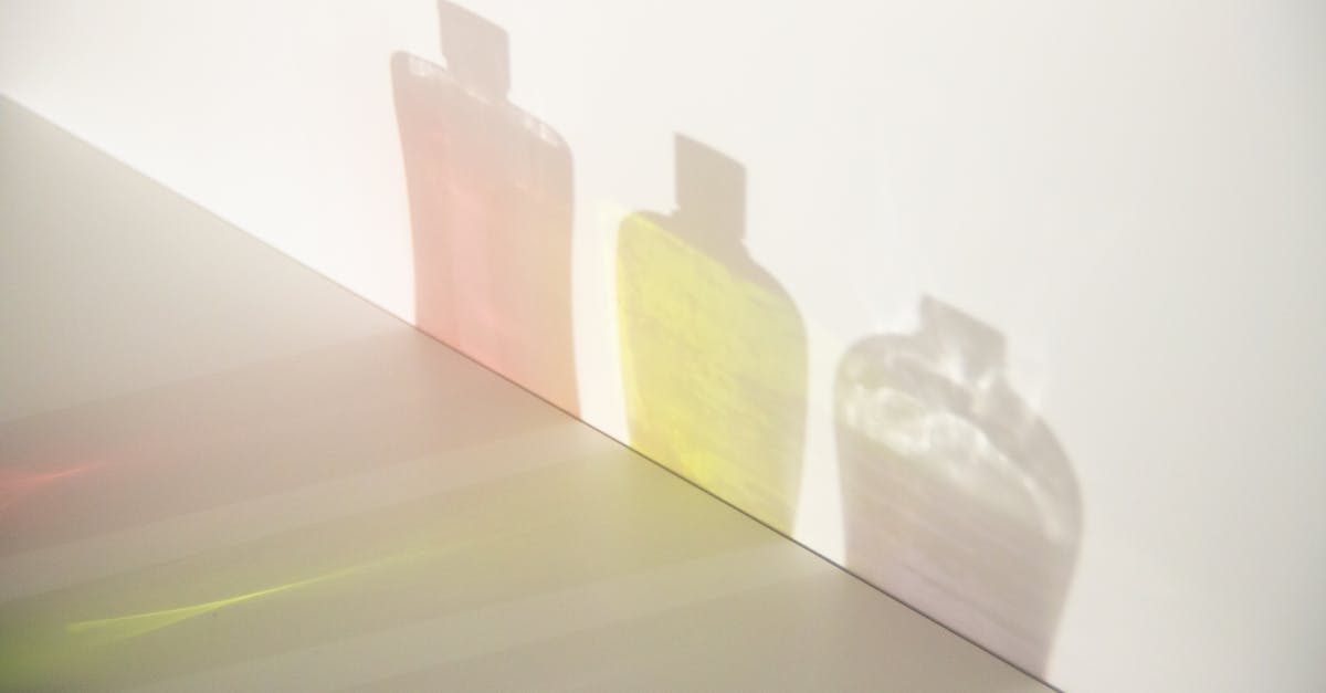 How do I make Skyrim run smooth and stable with a high "uGridsToLoad" setting? - From above of different bottle shadows with bright liquids and caps in row on smooth surface