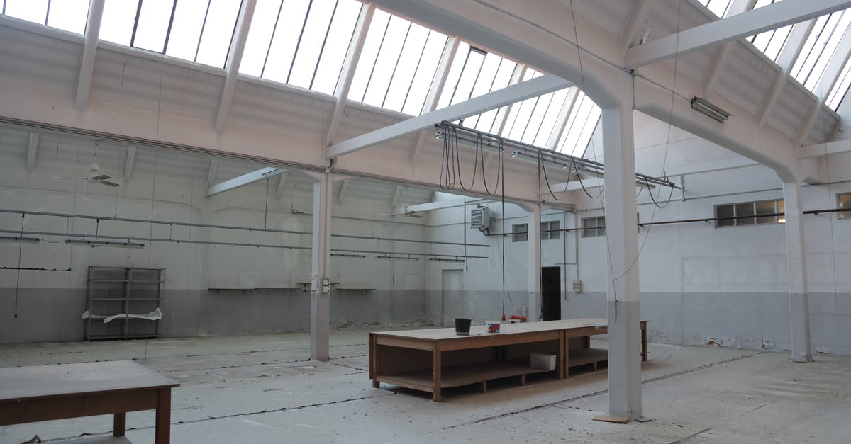 How do I meet fractional amounts of Refined Metal for trades? - Bright premise for storage with concrete floor and metal beams inside modern industrial building