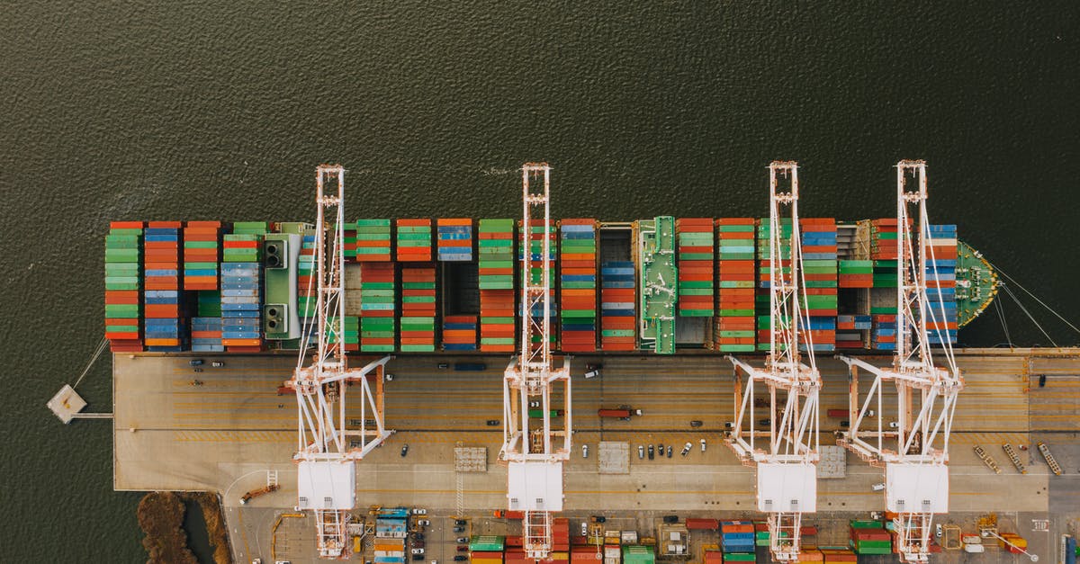 How do I meet fractional amounts of Refined Metal for trades? - Colorful cargo containers on ship near pier