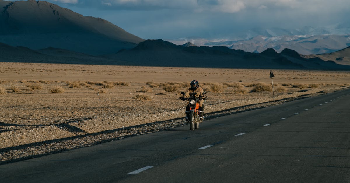 How do I move a rock? - Unrecognizable biker riding motorcycle in countryside How do I move a rock? - Unrecognizable biker riding motorcycle in countryside