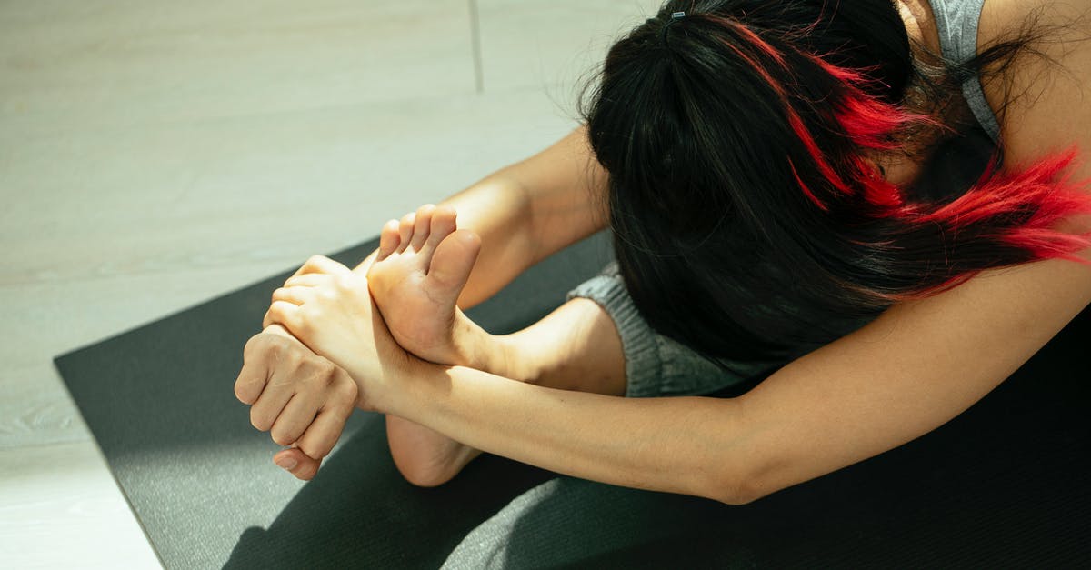 How do I move Forward from Here? - Anonymous barefooted woman performing Head to Knee I yoga asana on mat