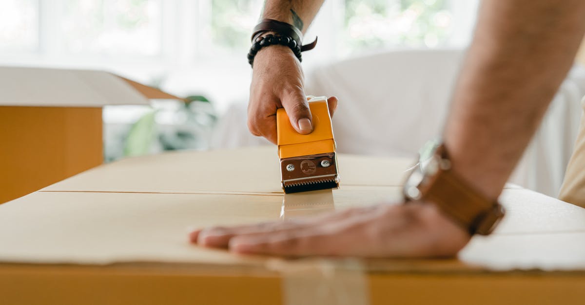 How do I move only part of the items at a time? - Crop man packing carton box with scotch tape dispenser
