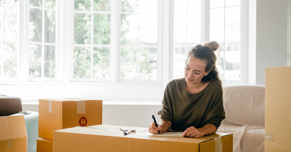 How do I open the new dreamy content in Candy Crush? - Content lady in casual clothes writing with pen on cardboard box while sitting near window in daylight in apartment preparing to relocate How do I open the new dreamy content in Candy Crush? - Content lady in casual clothes writing with pen on cardboard box while sitting near window in daylight in apartment preparing to relocate