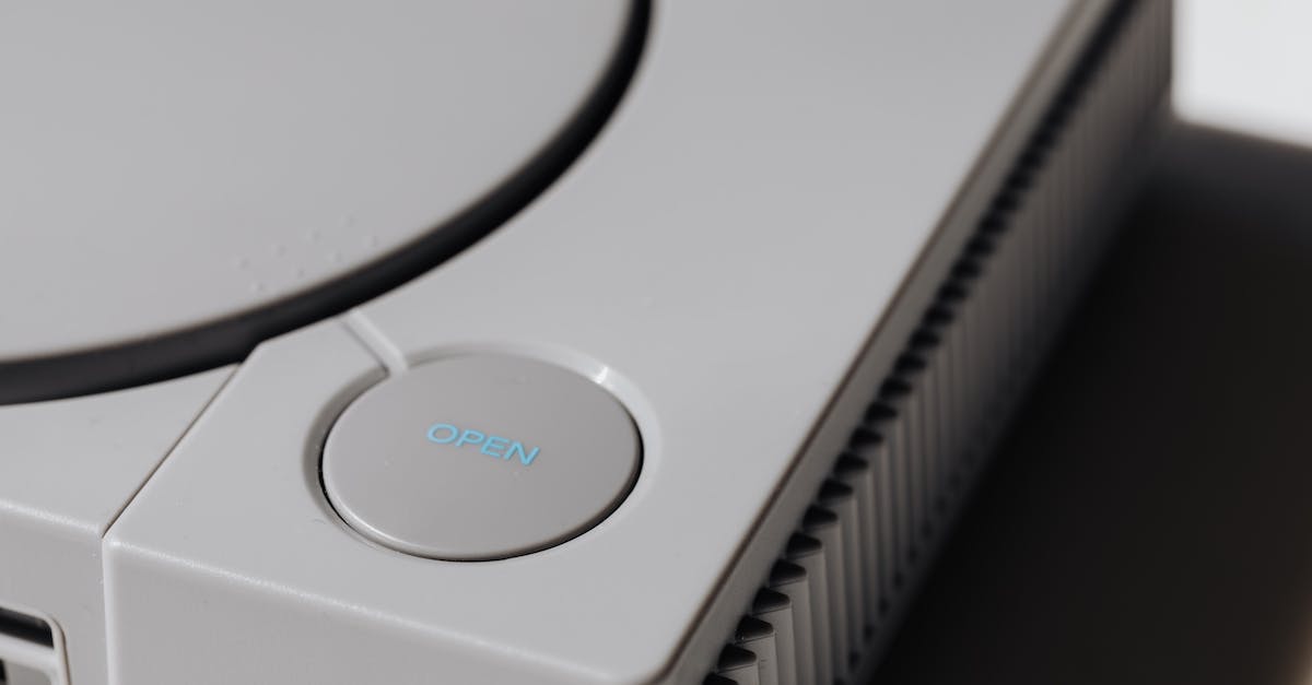 How do I open this game? - Close-Up Photo of Gray Video Game Console
