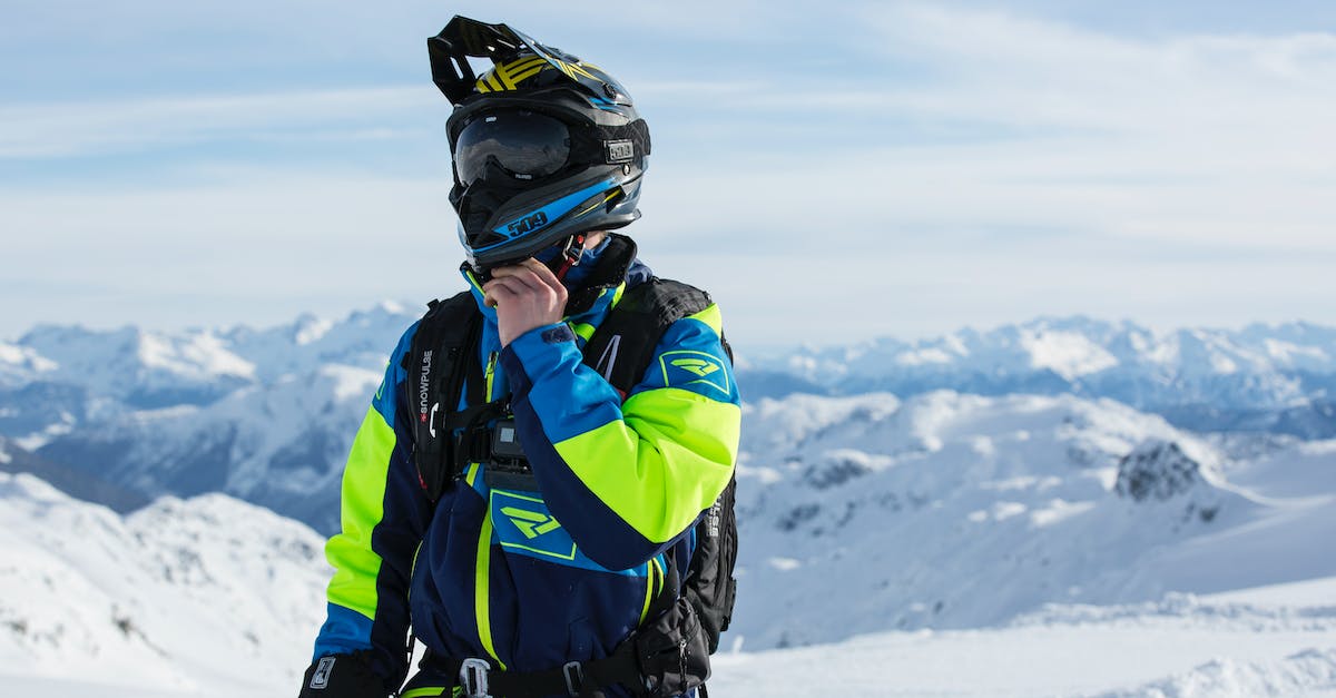 How do I perform the infinite Ice Climber grab? - Man in Green and Blue Jacket Standing on Winter Season