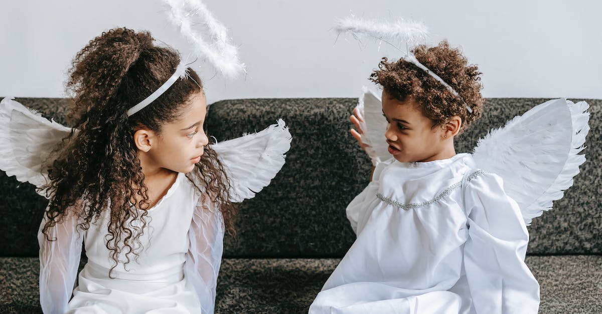 How do I play Halo 4 against bots? - Cute little black siblings in angels costumes playing on couch