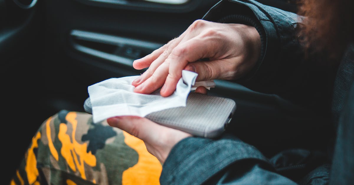 How do I prevent pouch items from auto-refilling? - Crop person wiping smartphone with napkin How do I prevent pouch items from auto-refilling? - Crop person wiping smartphone with napkin