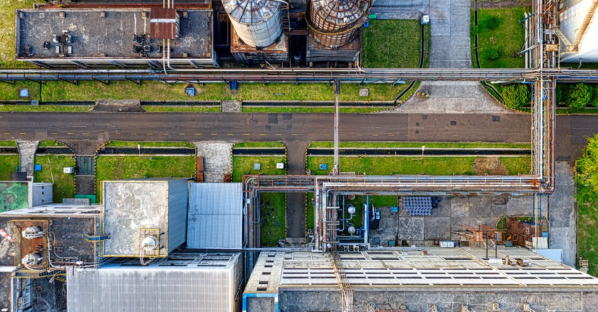 How do I produce steel in Kittens? - Aerial view of old factory with tanks and facility for industrial production located along road How do I produce steel in Kittens? - Aerial view of old factory with tanks and facility for industrial production located along road