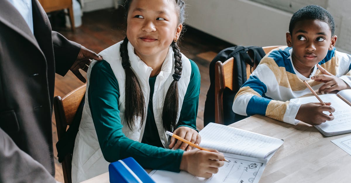 How do I question a witness with emotions instead of evidence? - Crop black teacher talking with smart multiethnic boy and girl siting at desk with notepads