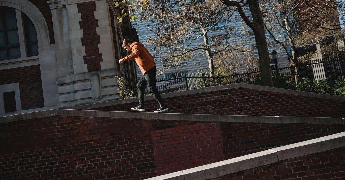 How do I rank up in Rocket League Season 2? - Man walking on brick building parapet