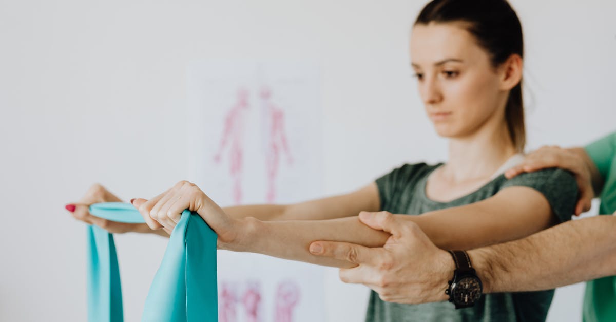 How do I reach the Arch-Mage? [duplicate] - Slim young female in casual wear standing with reached arms and elastic tape during medical checkup by crop unrecognizable osteopath in wristwatch