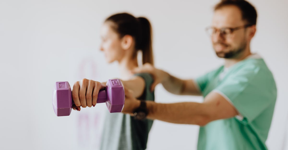 How do I reach the Arch-Mage? [duplicate] - Side view of professional orthopedist in uniform and eyewear helping fit woman reaching arm with dumbbell in doctor office on blurred background