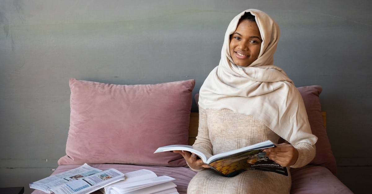 How do I read the stats on article pages on the Magic: The Gathering Website? - Positive black woman reading magazine sitting on sofa How do I read the stats on article pages on the Magic: The Gathering Website? - Positive black woman reading magazine sitting on sofa