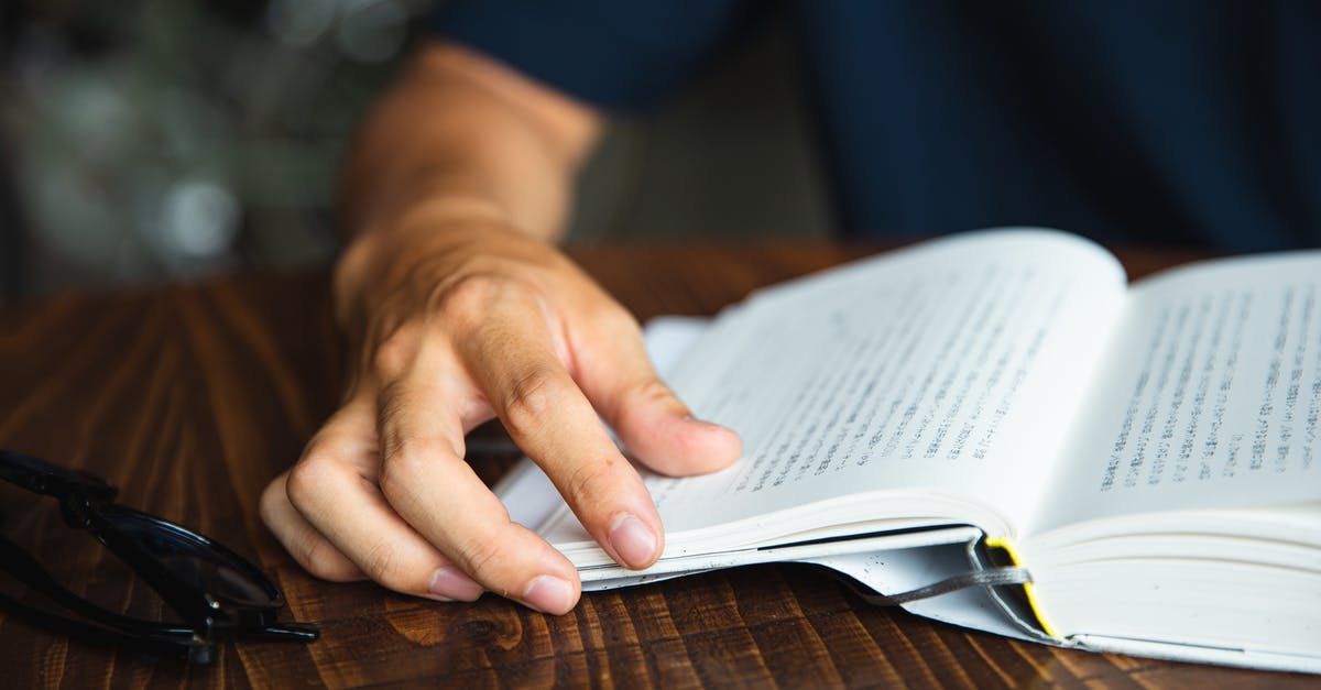 How do I read the stats on article pages on the Magic: The Gathering Website? - Crop unrecognizable man reading book at table How do I read the stats on article pages on the Magic: The Gathering Website? - Crop unrecognizable man reading book at table