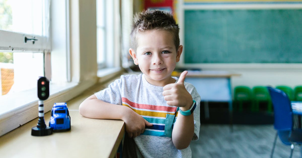 How do I re-enable the windows key while playing a game? - Little Boy in Gray Shirt in Thumbs Up Gesture