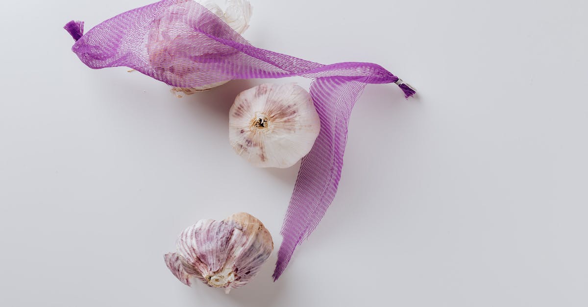 How do I remove a net from a dodo without killing it? - Composition of garlic bulbs with purple net on white background How do I remove a net from a dodo without killing it? - Composition of garlic bulbs with purple net on white background
