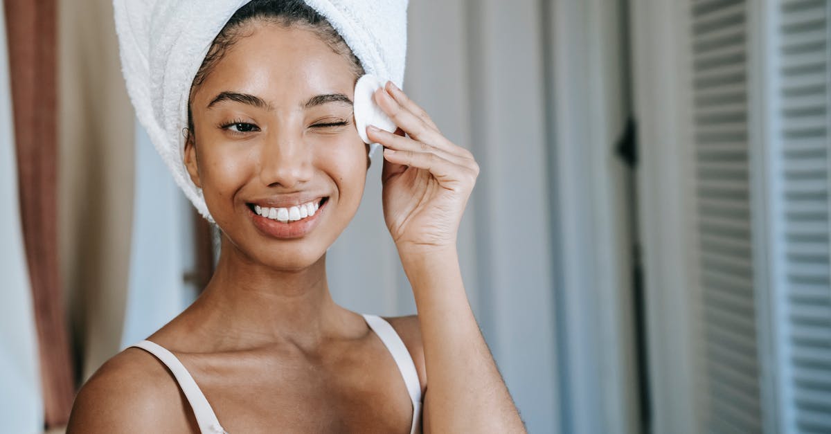 how do I remove positive potion effects? - Smiling ethnic woman wiping face skin in morning how do I remove positive potion effects? - Smiling ethnic woman wiping face skin in morning