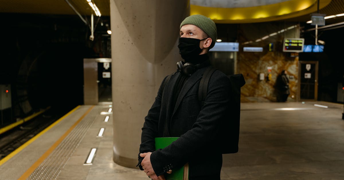 How do I remove subway routes? - A Man in Black Coat Wearing Face Mask While Waiting on the Station