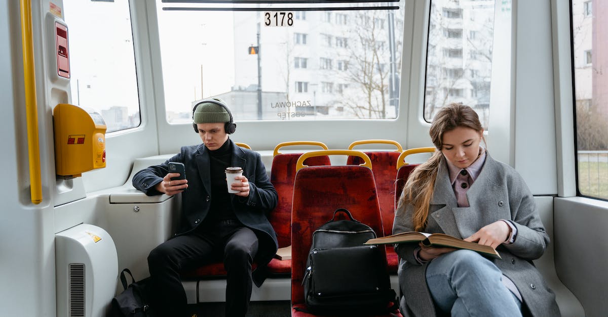 How do I remove subway routes? - A Woman in Gray Coat Reading a Book while Sitting Near the Man Wearing Headphones while Holding His Mobile Phone How do I remove subway routes? - A Woman in Gray Coat Reading a Book while Sitting Near the Man Wearing Headphones while Holding His Mobile Phone