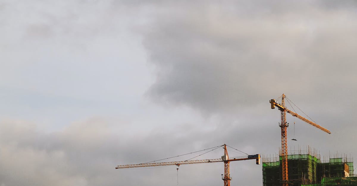 How do I replicate a chain lift? - Bright high cranes near urban house during construction under cloudy sky in daylight How do I replicate a chain lift? - Bright high cranes near urban house during construction under cloudy sky in daylight
