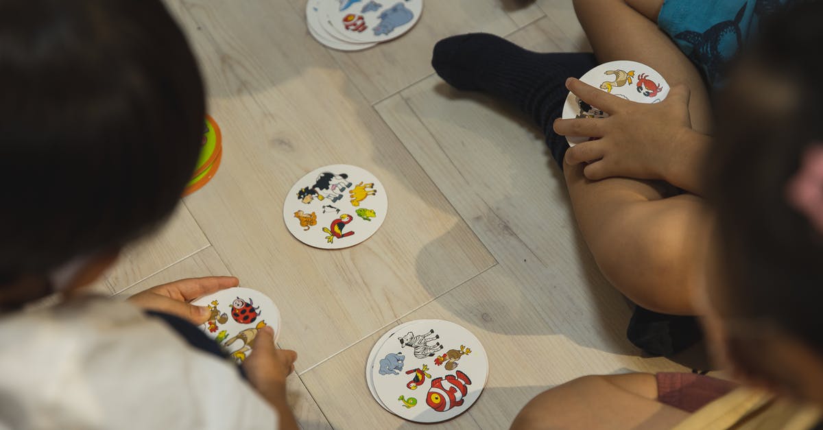 How do I restart my Animal Crossing game? - Crop group of ethnic children playing game with illustrated cards