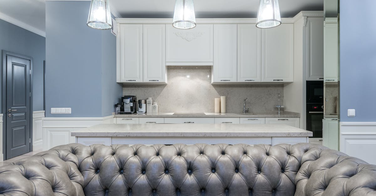 How do I restart on a new island in Battle Islands on PS4? - Interior of modern apartment with comfortable couch and glowing lamps in kitchen near with white cabinets and island counter