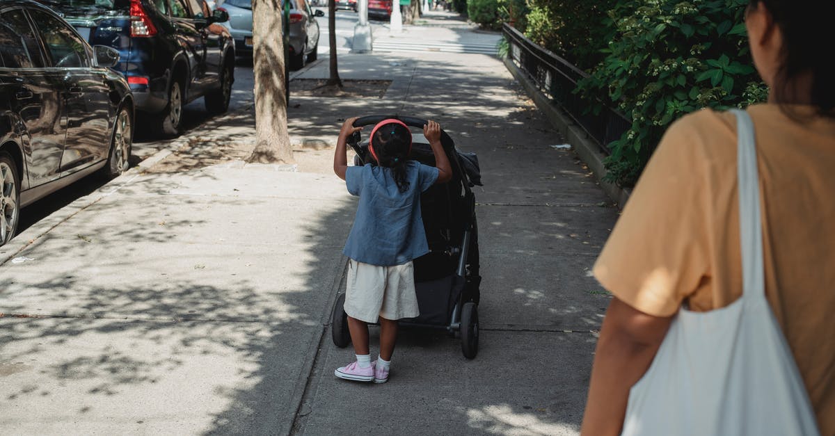 How do I roll back versions? - Unrecognizable ethnic girl pushing carriage on walkway How do I roll back versions? - Unrecognizable ethnic girl pushing carriage on walkway