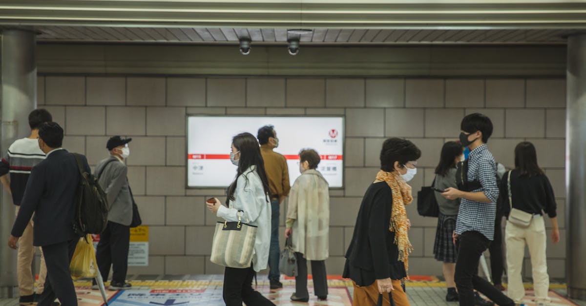 How do I safely energize a hungry node without risk of degrading the node or worse? - Ethnic people walking in underground passage in masks