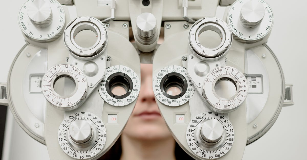 How do I scan a star? - Woman diagnosing vision on refractor testing device during eye examination in modern ophthalmology clinic