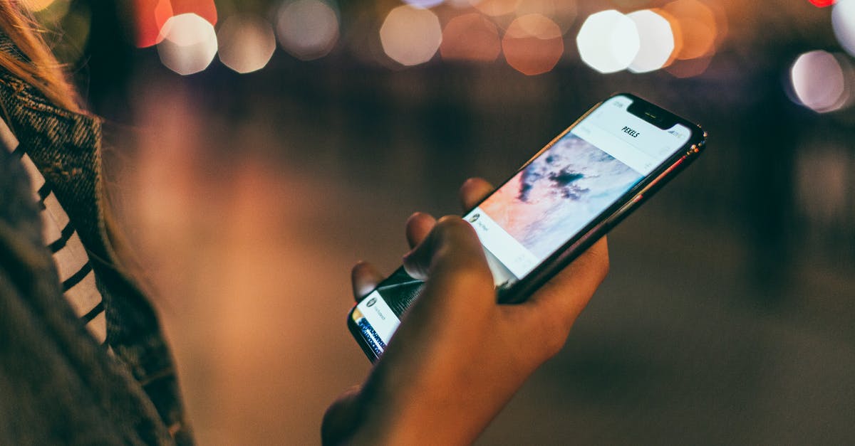How do I search photos by player ID? - Person Holding Space Gray Iphone X How do I search photos by player ID? - Person Holding Space Gray Iphone X