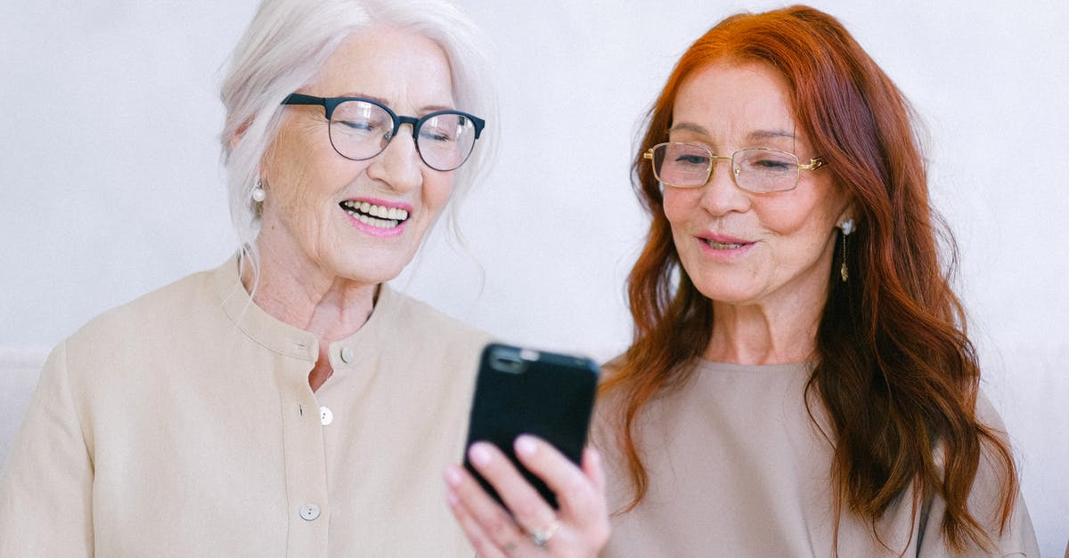 How do I share quests with my friends in Star Wars: The Old Republic? - Cheerful aged women smiling and watching video online on smartphone