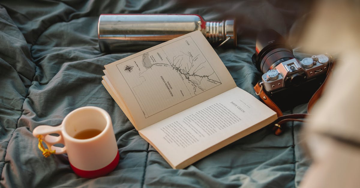 How do I smash open a Bottle? - From above of open textbook between mug of hot drink and retro photo camera on crumpled fabric How do I smash open a Bottle? - From above of open textbook between mug of hot drink and retro photo camera on crumpled fabric