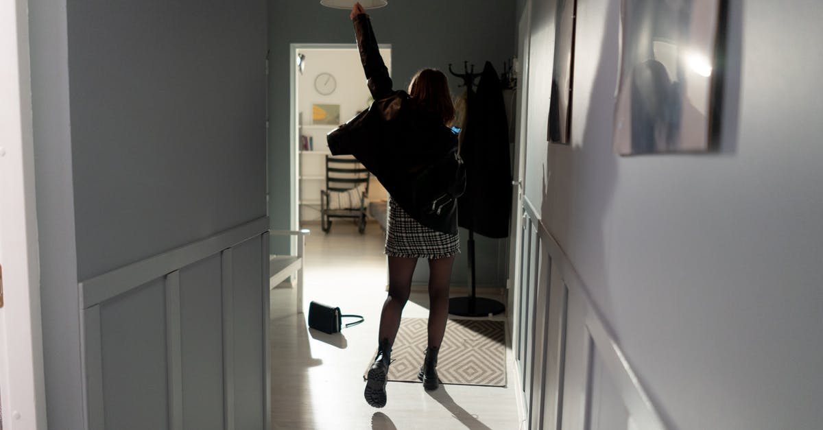 How do I spawn a zombie wearing a helmet? - Woman in Black Long Sleeve Shirt and Black and White Polka Dot Skirt Standing on Hallway
