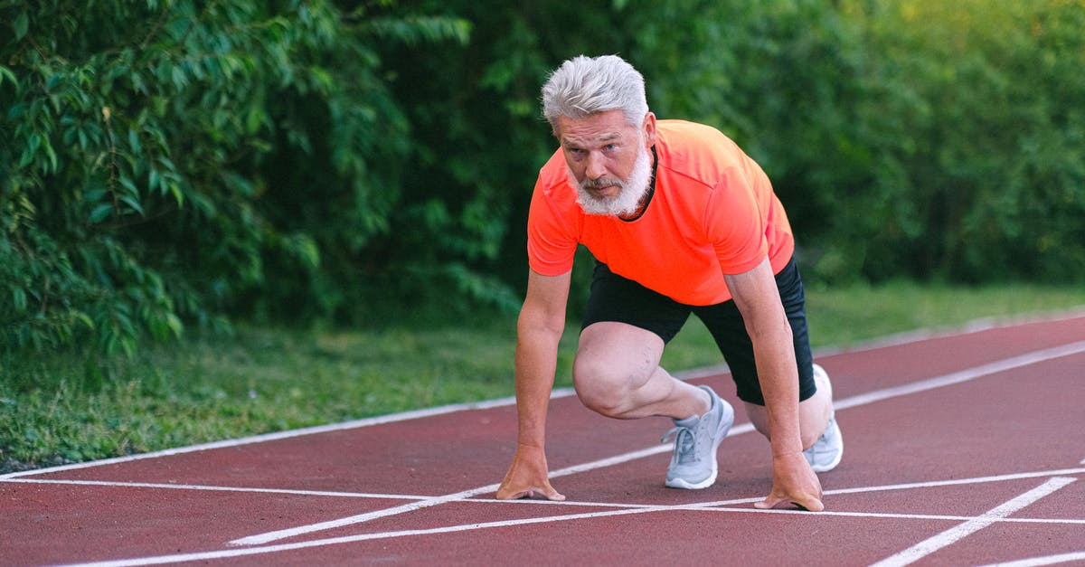 How do I start the crossbow challenge? - Serious strong elderly man starting for run in racetrack