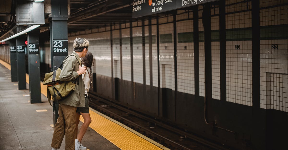 How do I stop Freeciv from animating every move when observing an AI player? - Side view of unrecognizable young man and woman in trendy outfits and backpack looking away while waiting for train in underground station