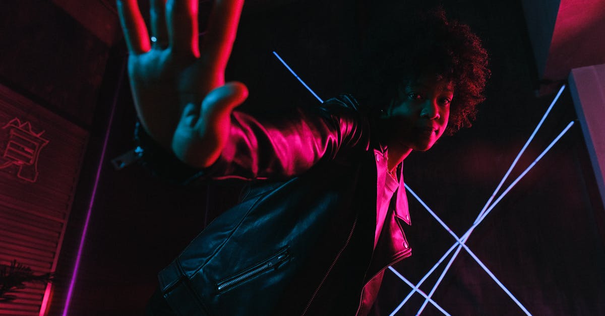 How do I stop my name from being invisible? [duplicate] - Low angle of trendy black female adolescent leaning forward while demonstrating control gesture and looking at camera against lamps at night