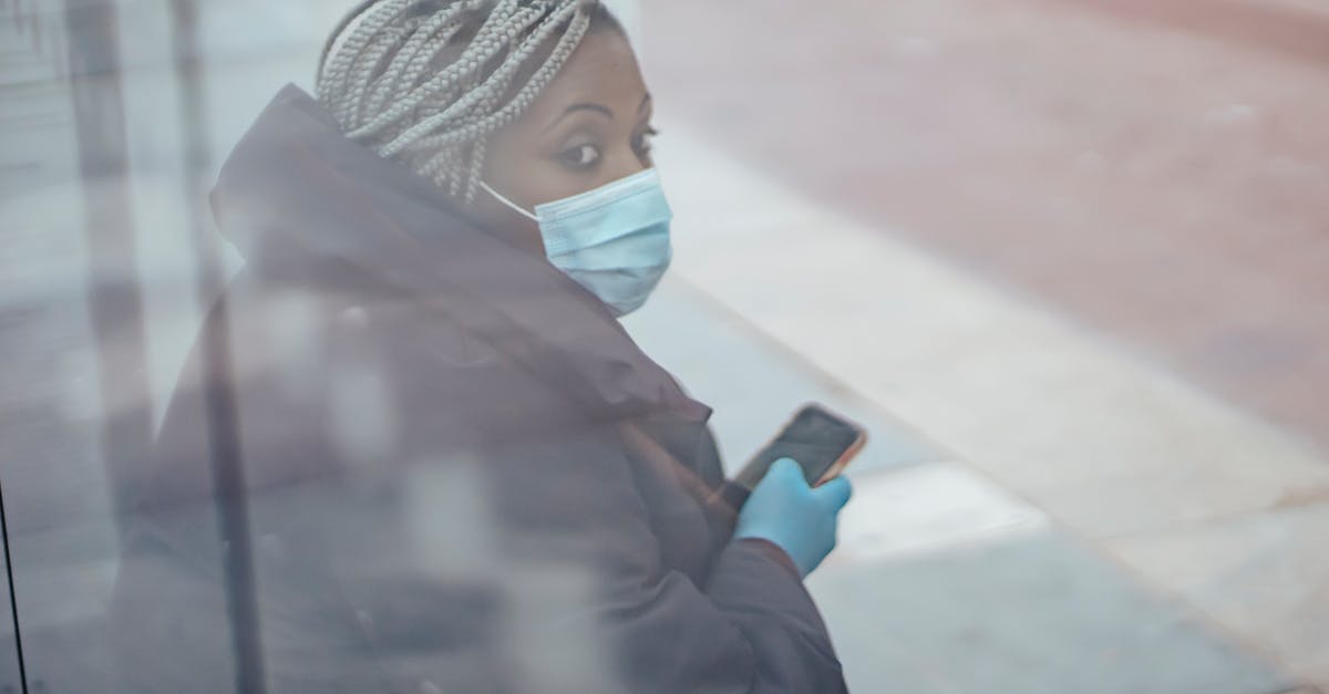 How do I stop the spread of corruption through my desert? [duplicate] - Through glass wall side view of mature ethnic female medic in outerwear with cellphone looking away in town