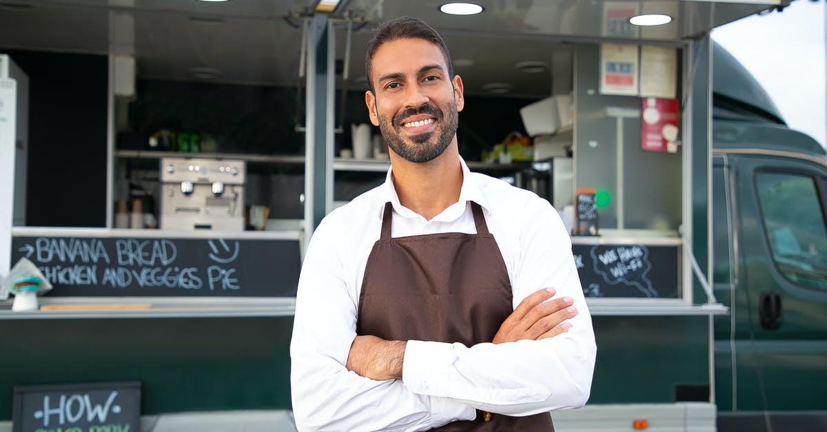 How do I summon an armor stand with arms that will work? - Smiling young ethnic male waiter in apron standing with arms folded near modern food truck and looking at camera contentedly How do I summon an armor stand with arms that will work? - Smiling young ethnic male waiter in apron standing with arms folded near modern food truck and looking at camera contentedly